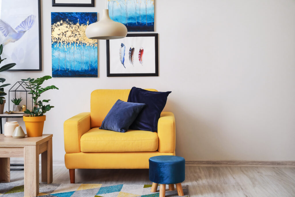 bright living room, yellow chair, art on wall